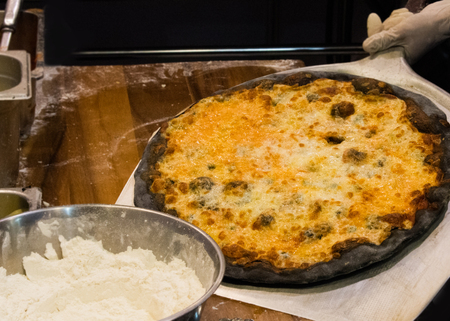 chef prepares delicious pizzas on the kitchen, view from the inside of the ovenの写真素材