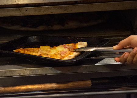 chef prepares delicious pizzas on the kitchen, view from the inside of the ovenの写真素材