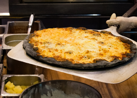 chef prepares delicious pizzas on the kitchen, view from the inside of the ovenの写真素材