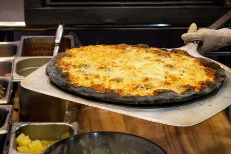 chef prepares delicious pizzas on the kitchen, view from the inside of the ovenの写真素材