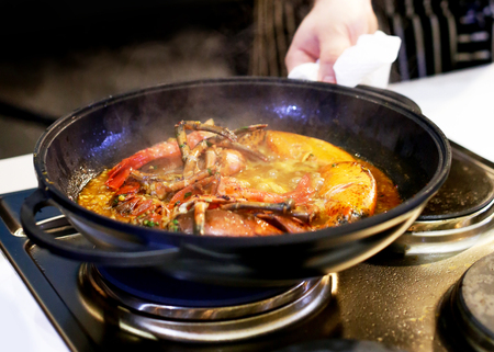 Chef cooking food in the kitchen, Traditional Spanish paellaの写真素材