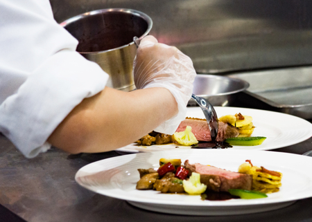 Chef preparing food, meal, in the kitchen, chef cooking, Chef decorating dish, closeupの写真素材