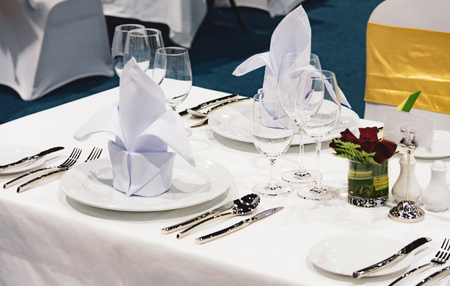 Table setting in the restaurant, water in the grass on the dining table, glass of water on tableの写真素材