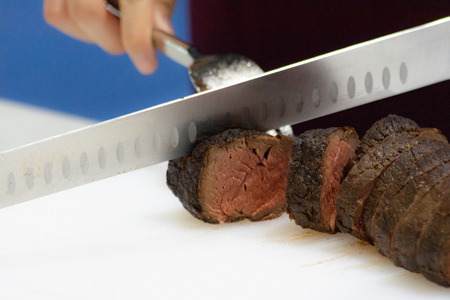 Roast beef and slice, chef's hands cutting roast beef, Carving roast beefの写真素材