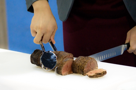 Roast beef and slice, chef's hands cutting roast beef, Carving roast beefの写真素材