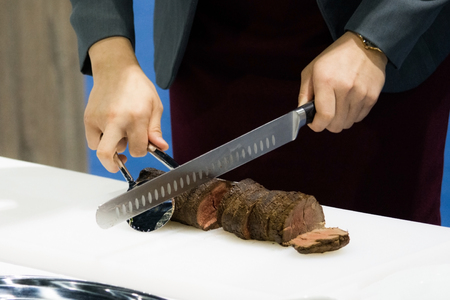 Roast beef and slice, chef's hands cutting roast beef, Carving roast beefの写真素材