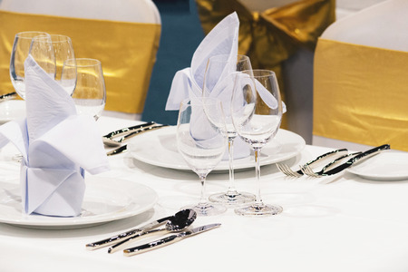 Table setting in the restaurant, water in the grass on the dining table, glass of water on tableの写真素材