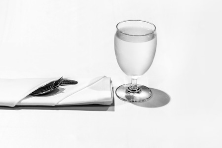 Table setting in the restaurant, water in the grass on the dining table, glass of water on tableの写真素材