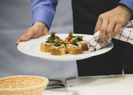 Decorating The Food In The Restaurant, Waiter is working on finishing a dish, diner waiter sandwichesの写真素材