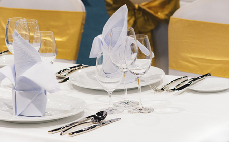 Table setting in the restaurant, water in the grass on the dining table, glass of water on tableの写真素材