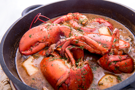 Traditional spanish paella rice with lobster and meat on panの写真素材