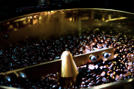 Roasted coffee in coffee roaster, Machine for roasting coffee close up, bean roastingの写真素材