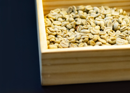 Raw coffee seeds, Coffee beans in a wood box close-upの写真素材