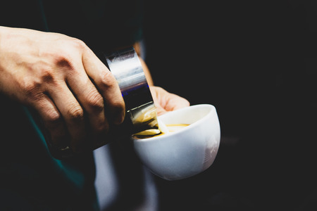 Barista working in a coffee shop, Close up of barista presses ground coffee using tamper, Barista Make Coffee Portafilter Conceptの写真素材