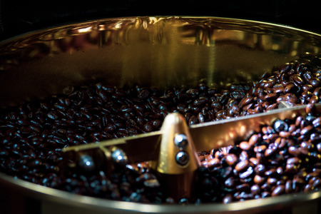 Roasted coffee in coffee roaster, Machine for roasting coffee close up, bean roastingの写真素材