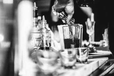 Bartender making alcohol cocktail at bar counter at nightclub, barman is making cocktailの写真素材