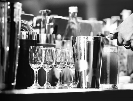 Bartender making alcohol cocktail at bar counter at nightclub, barman is making cocktailの写真素材