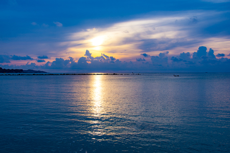 Sunset sky reflect on the sea, Light and cloud of the sunset is peacefulの写真素材