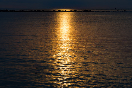 Sunset sky reflect on the sea, Light and cloud of the sunset is peacefulの写真素材