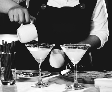 Bartender making alcohol cocktail at bar counter at nightclub, barman is making cocktailの写真素材