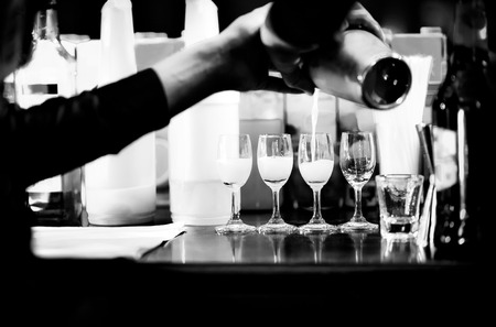 Bartender making alcohol cocktail at bar counter at nightclub, barman is making cocktailの写真素材