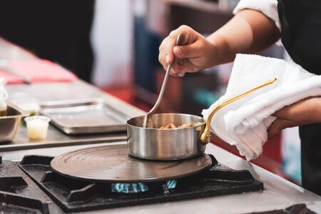 Chef preparing food in the kitchen, chef cooking, Chef decorating dish, closeup