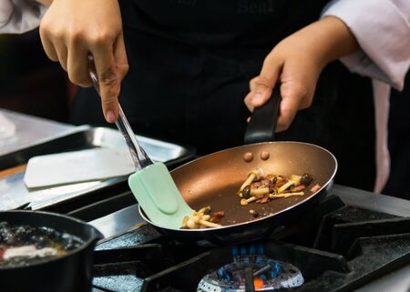 Chef cooking food in the kitchen, Chef preparing foodの写真素材
