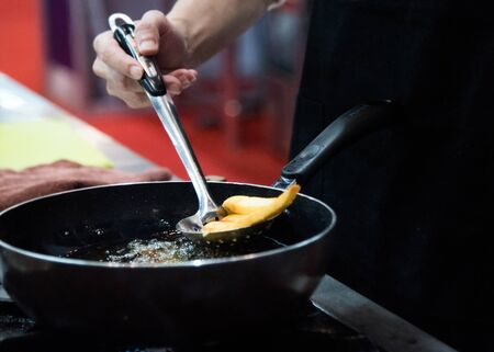 Chef is cooking french fries in the kitchen, Chef cooking fried potato in pan