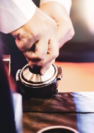Man pressing coffee powderの写真素材