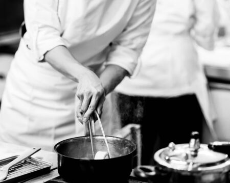 Chef cooking in a kitchenの写真素材