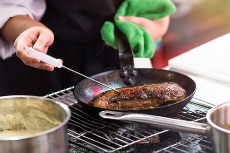 Chef cooking food in the kitchenの写真素材