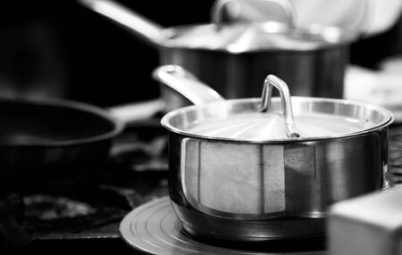 chef cooking in a kitchen, chef at work, black & white backgroundの写真素材