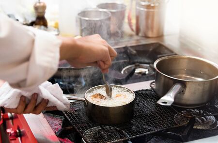 Chef cooking, Chef preparing food in the kitchen, Chef decorating dish, closeup