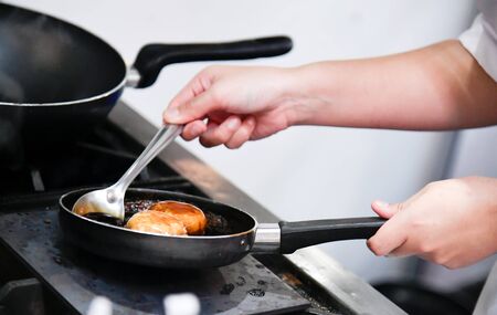 Chef cooking, Chef preparing food in the kitchen, Chef decorating dish, closeup
の写真素材