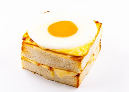 Tasty breakfast fried eggs and bread french fries  in a restaurantの写真素材