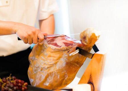 Chef Cutting slices of cured iberian ham