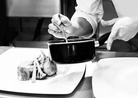 Chef preparing food in the kitchenの写真素材