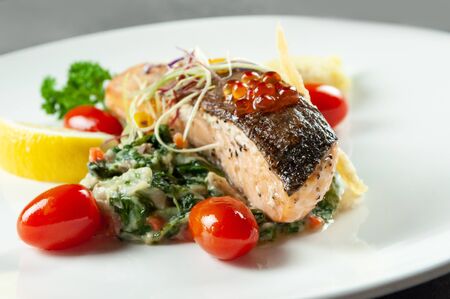 Tasty friend salmon, Grilled Salmon Steak with Spinachの写真素材