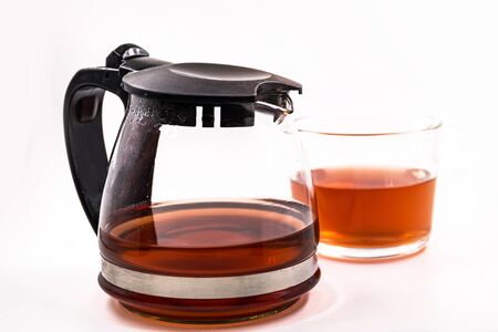 Teapot and cup with tea  on white backgroundの写真素材