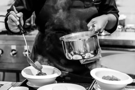 Chef cooking in a kitchen, chef at work, Black & Whiteの写真素材