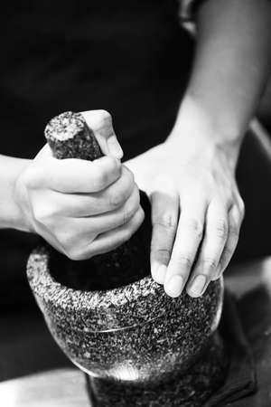 Chili in stone mortar in thai kitchen style, chef cookingの写真素材