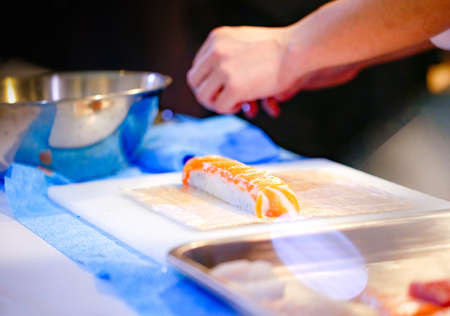 chef hands preparing japanese food, chef making sushi, Preparing Maki Sushi rollの写真素材
