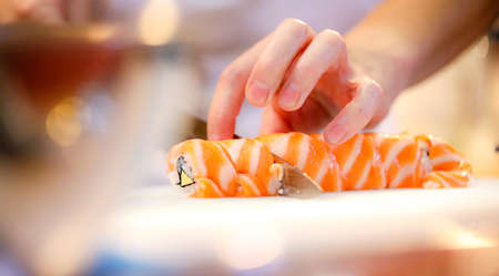 chef hands preparing japanese food, chef making sushi, Preparing Maki Sushi rollの写真素材