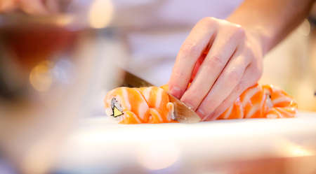 chef hands preparing japanese food, chef making sushi, Preparing Maki Sushi rollの写真素材