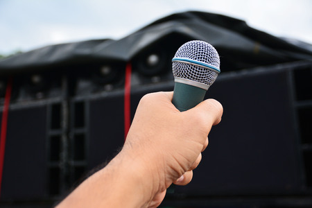 Men hand with microphone close up selective focusの写真素材