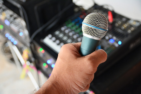 Men hand with microphone close up selective focusの写真素材