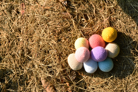 Knitting Easter eggs with rabbit on the grassの写真素材