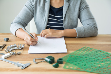 Jewelry designer is drawing sketch works