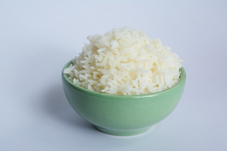 Jasmine rice in bowl on white backgroundの写真素材