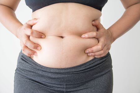 Chubby woman with belly fat on white backgroundの写真素材